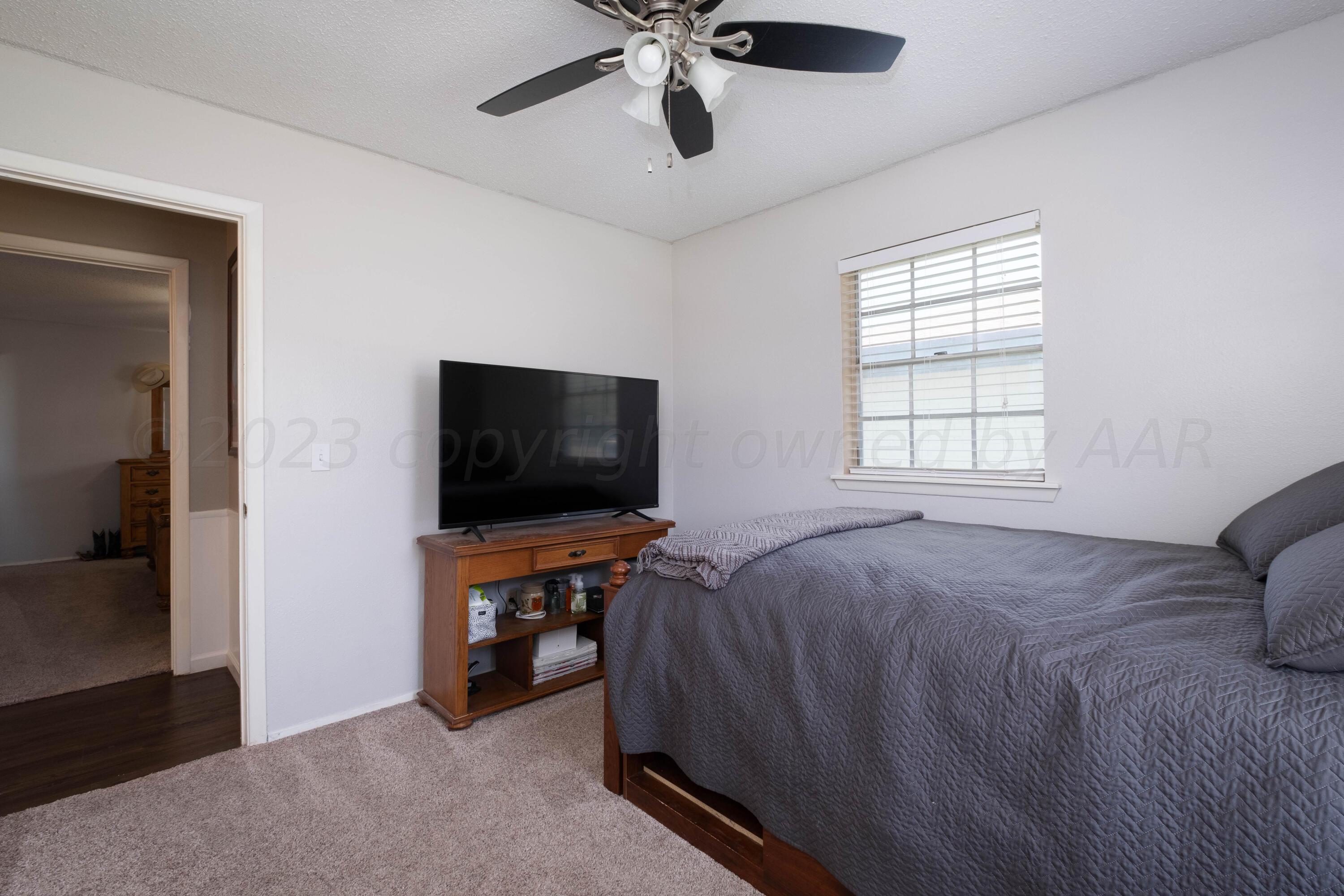 4813 South Rusk Street Amarillo, TX 79110 - Photo 4 of 23 a bed room with a bed and a television