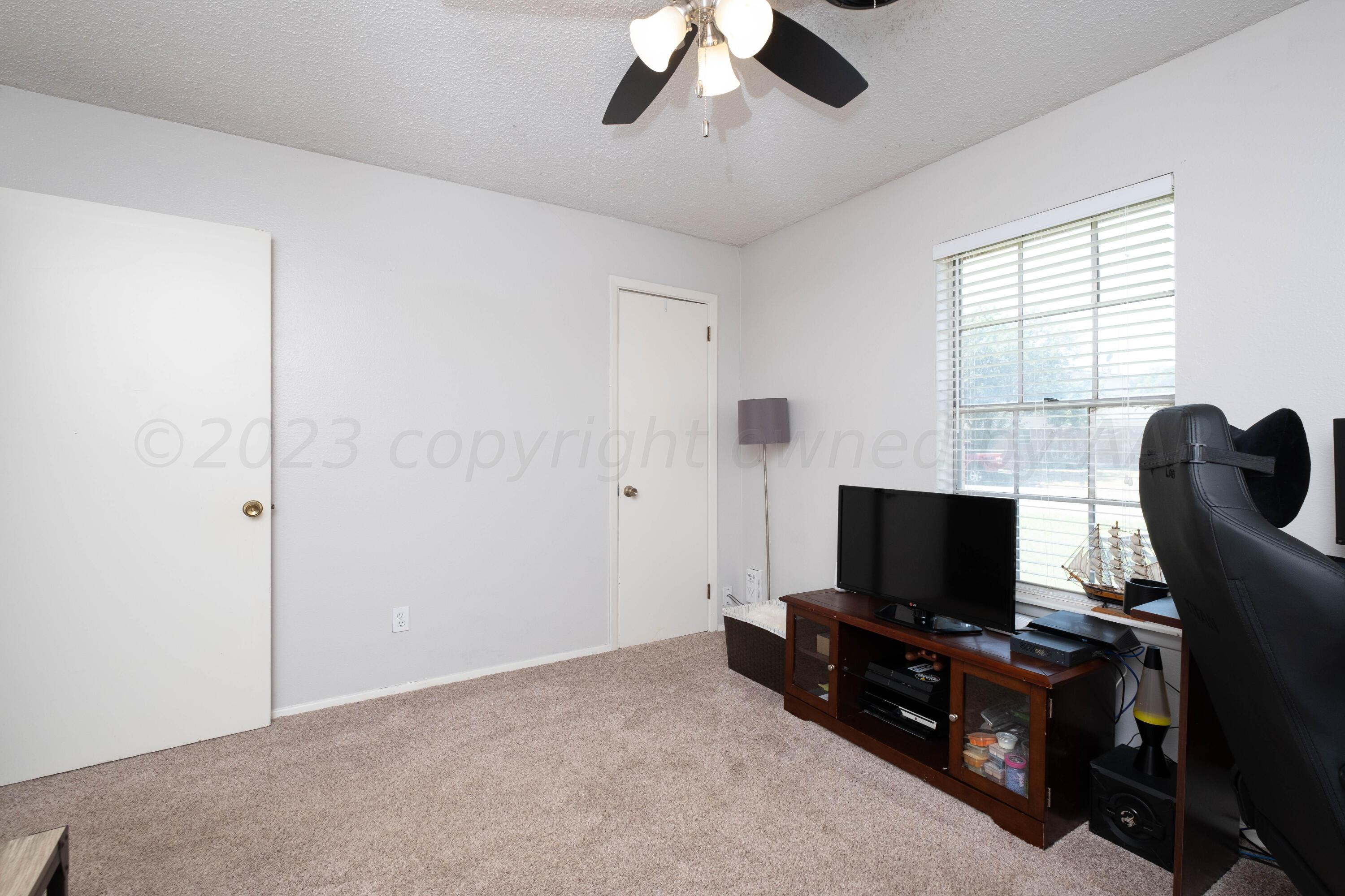 4813 South Rusk Street Amarillo, TX 79110 - Photo 5 of 23 a living room with furniture and a flat screen tv