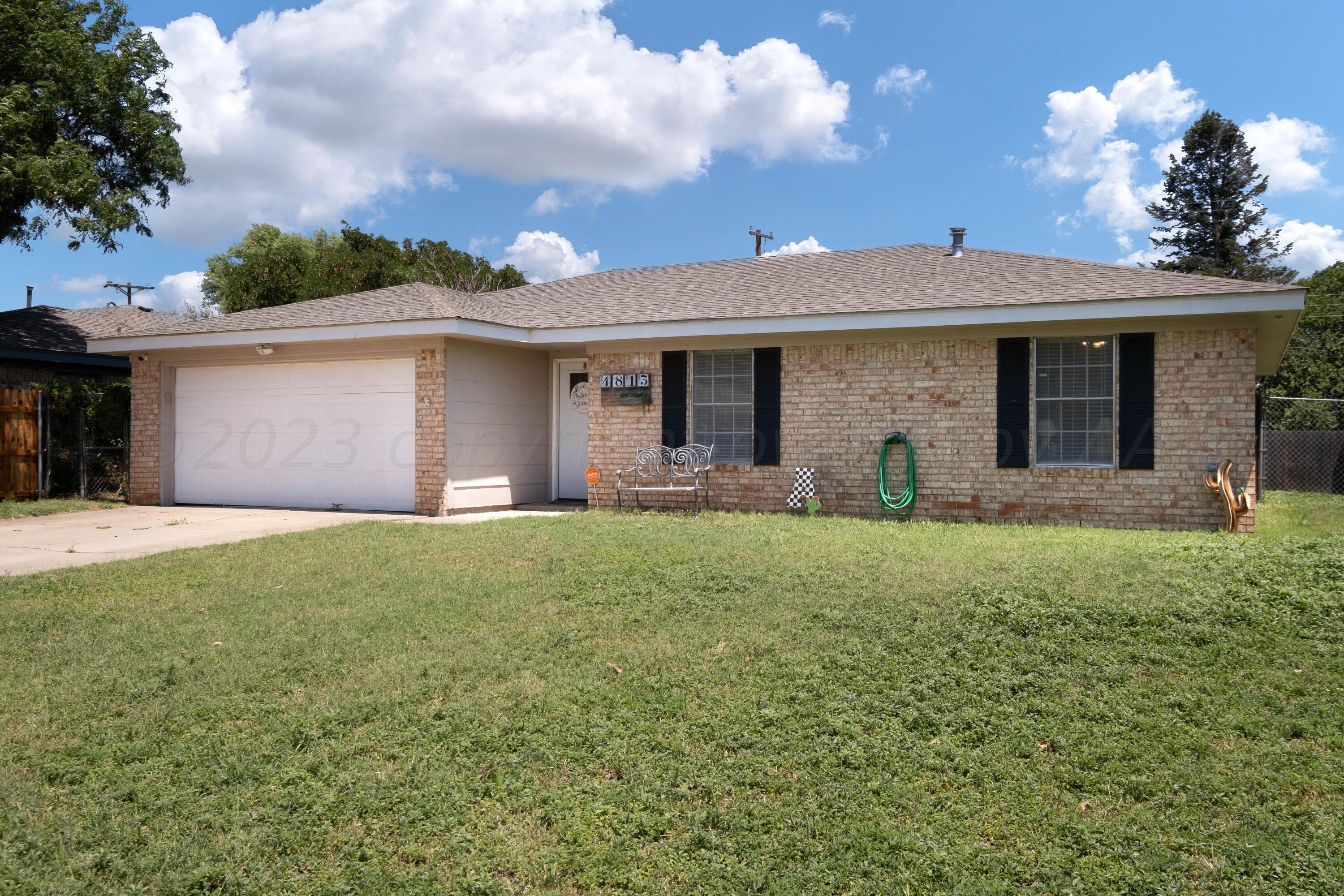 4813 South Rusk Street Amarillo, TX 79110 - Photo 6 of 23 a view of a house with yard and a garden