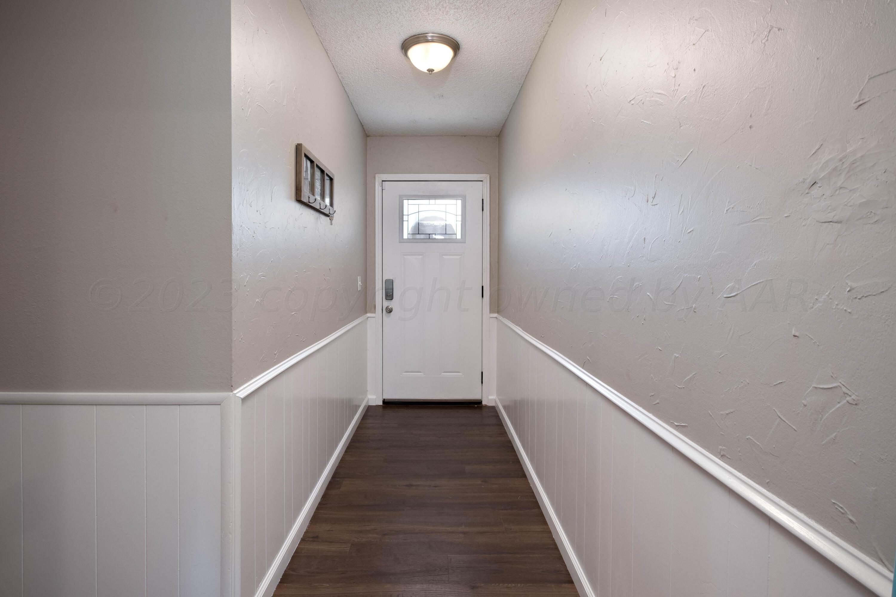 4813 South Rusk Street Amarillo, TX 79110 - Photo 8 of 23 a view of a hallway with wooden floor and staircase