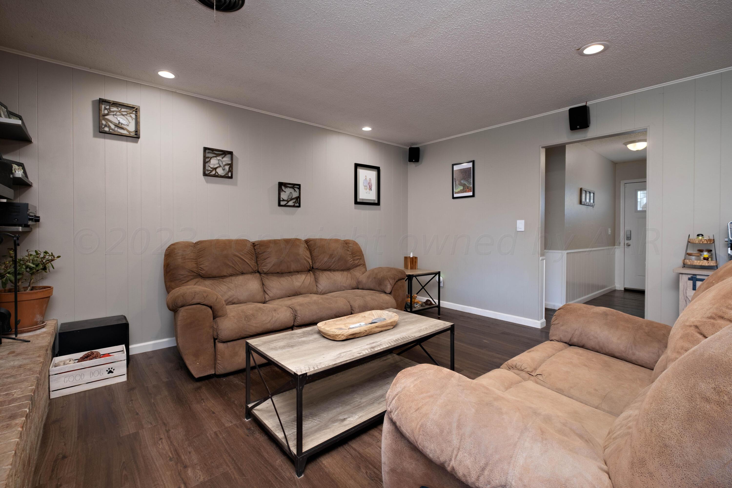 4813 South Rusk Street Amarillo, TX 79110 - Photo 9 of 23 a living room with furniture and a wooden floor