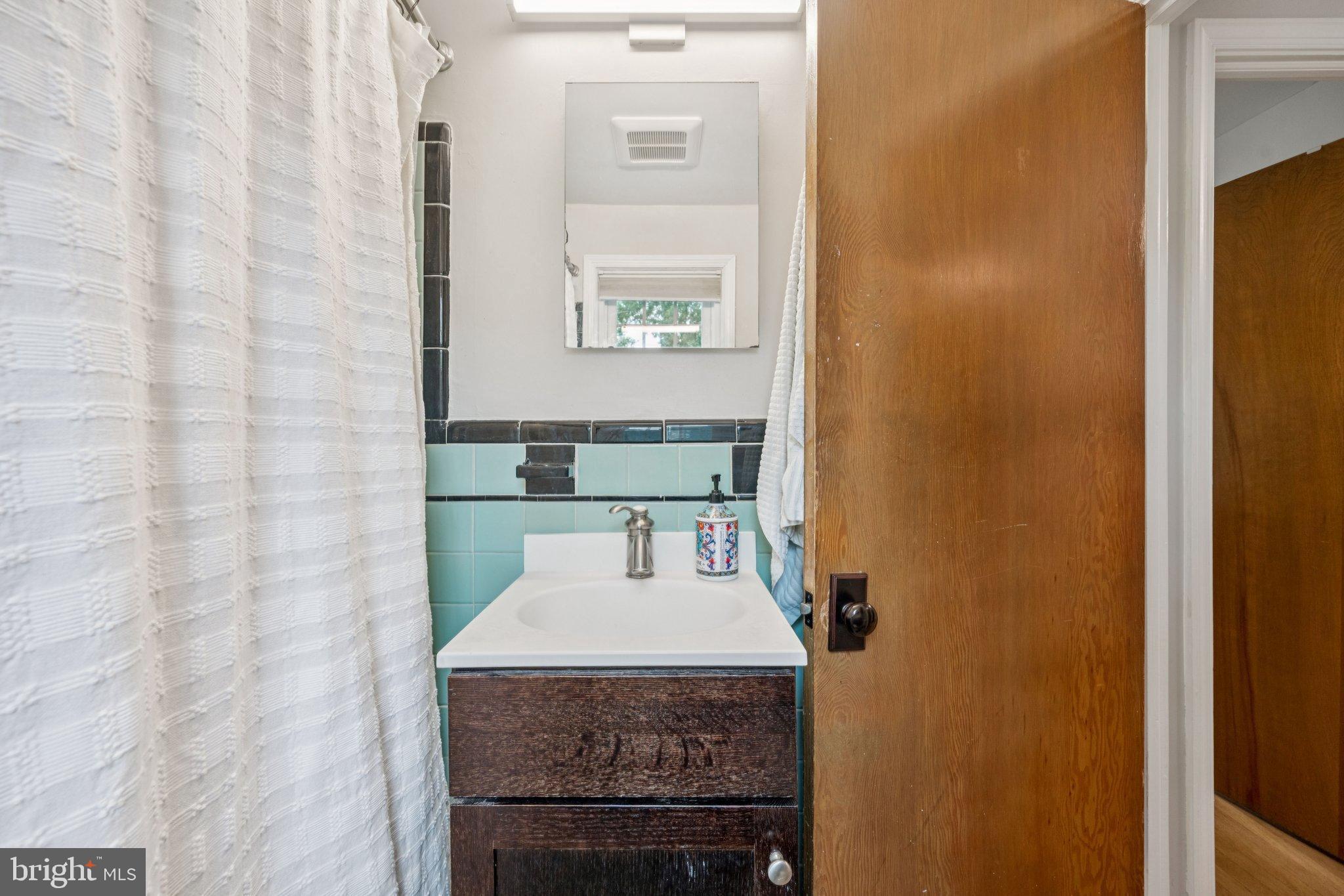 2307 Cheverly Avenue Cheverly, MD 20785 - Photo 17 of 25 a bathroom with a granite countertop sink and a mirror