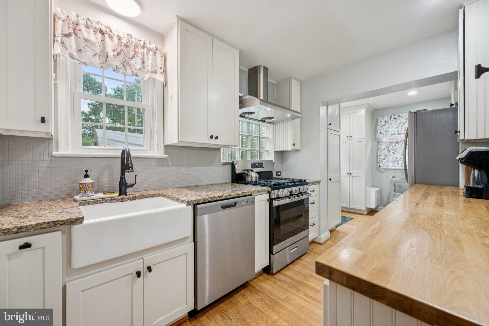 2307 Cheverly Avenue Cheverly, MD 20785 - Photo 7 of 25 a kitchen with a sink stove and refrigerator