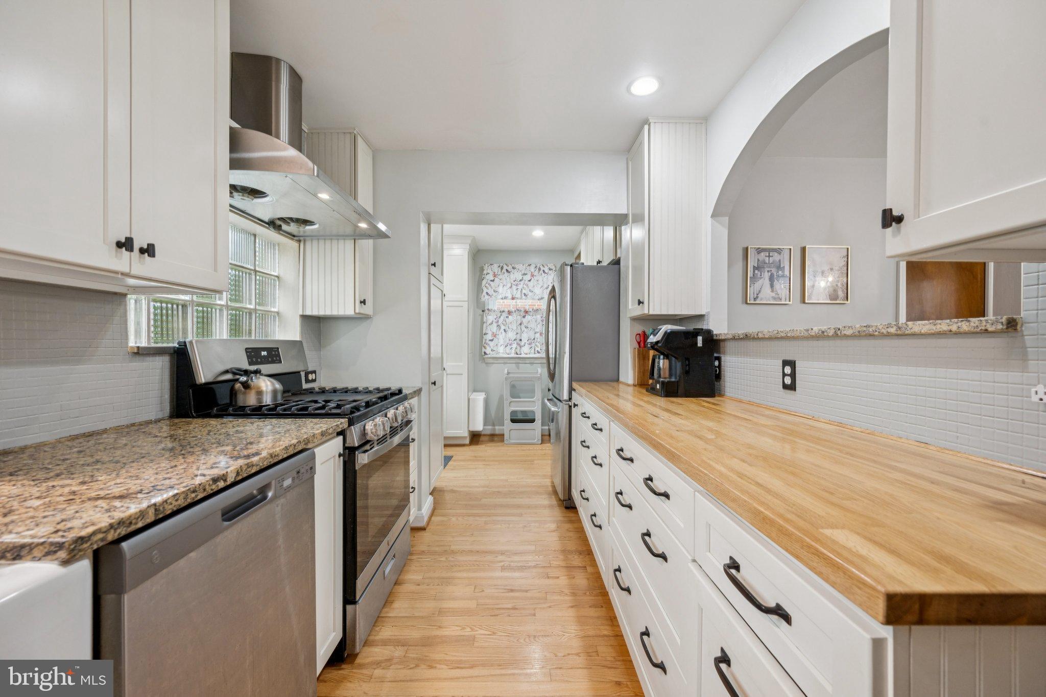 2307 Cheverly Avenue Cheverly, MD 20785 - Photo 8 of 25 a large kitchen with stainless steel appliances granite countertop a stove and a sink
