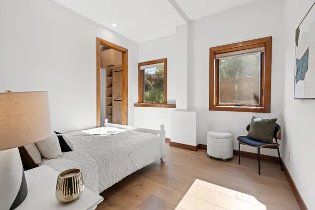 a spacious bedroom with a large bed and a large window