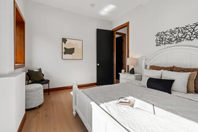 a bed room with a bed and a night stand