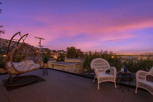 a view of swimming pool with outdoor seating and trees