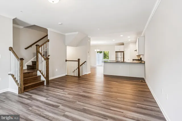 a view of a kitchen with wooden floor and stairs