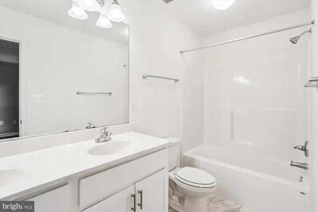 a bathroom with a sink toilet a mirror and shower