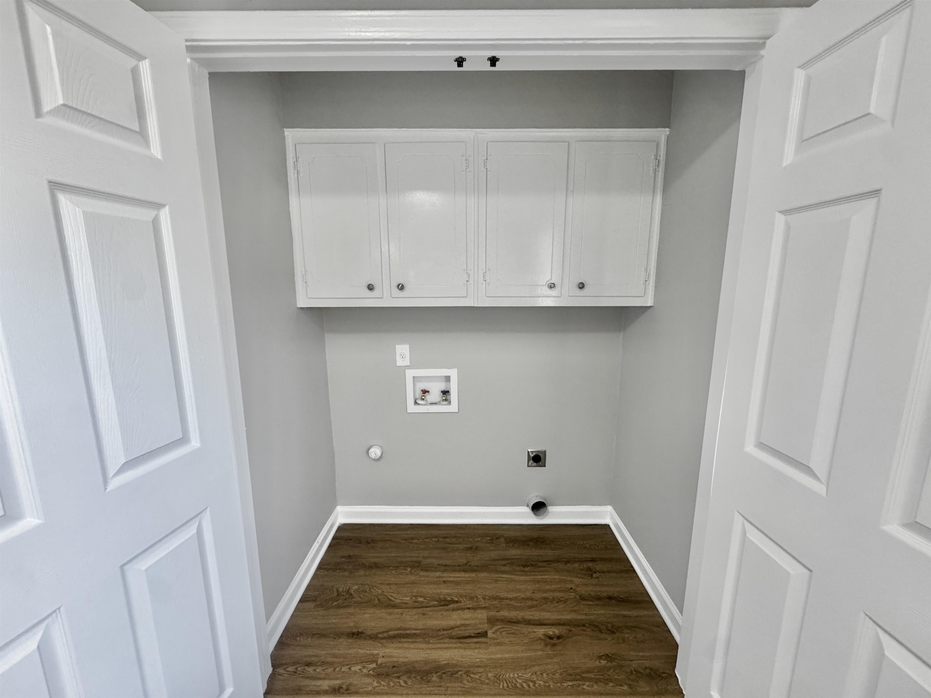 3429 Clarke Road Memphis, TN 38115 - Photo 11 of 33 Laundry area with hookup for a washing machine, cabinet space, dark wood-type flooring, and hookup for an electric dryer
