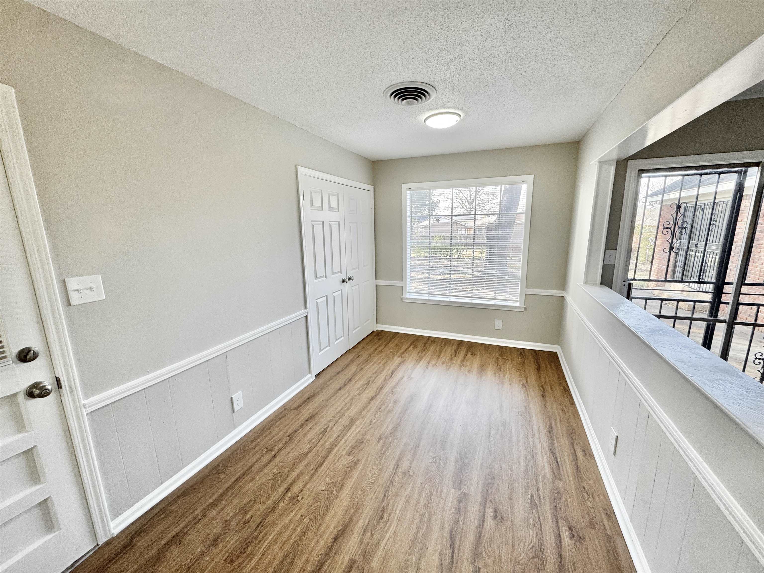 3429 Clarke Road Memphis, TN 38115 - Photo 12 of 33 a view of an empty room with wooden floor and a window
