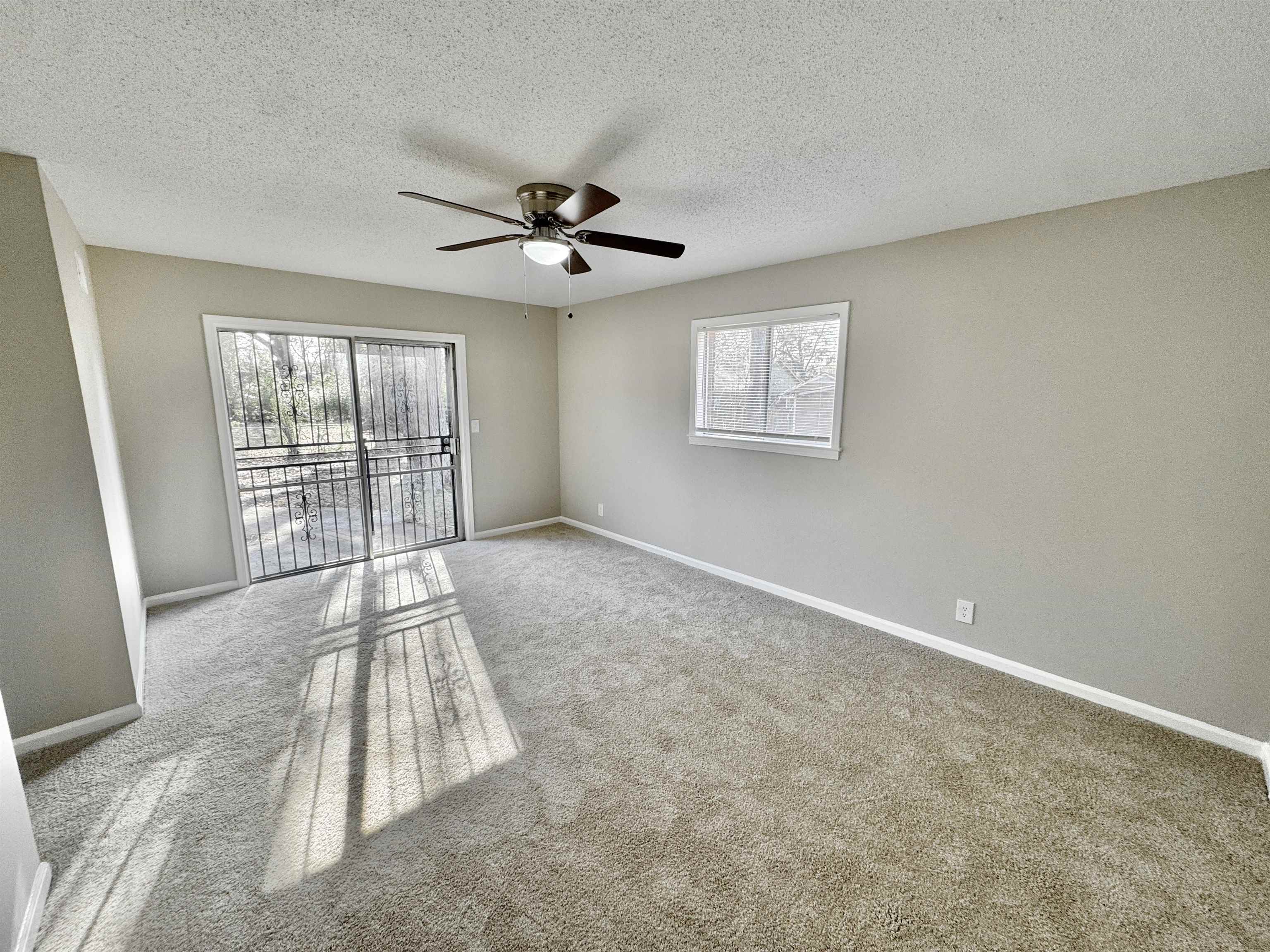 3429 Clarke Road Memphis, TN 38115 - Photo 18 of 33 an empty room with windows and ceiling fan