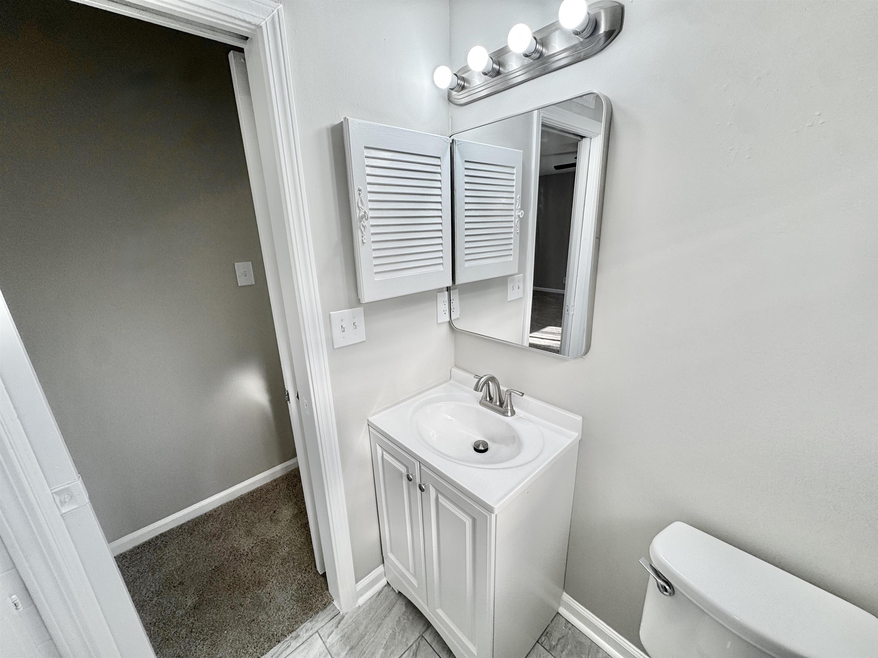 3429 Clarke Road Memphis, TN 38115 - Photo 20 of 33 a bathroom with a sink a toilet and mirror