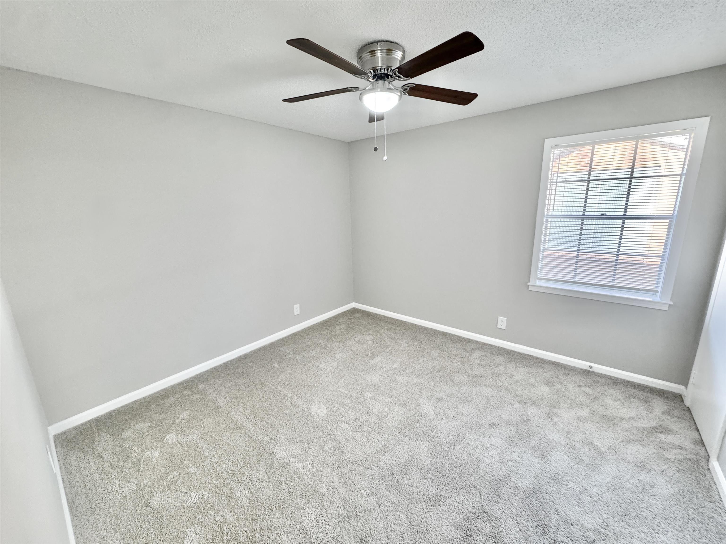 3429 Clarke Road Memphis, TN 38115 - Photo 22 of 33 an empty room with a ceiling fan and window