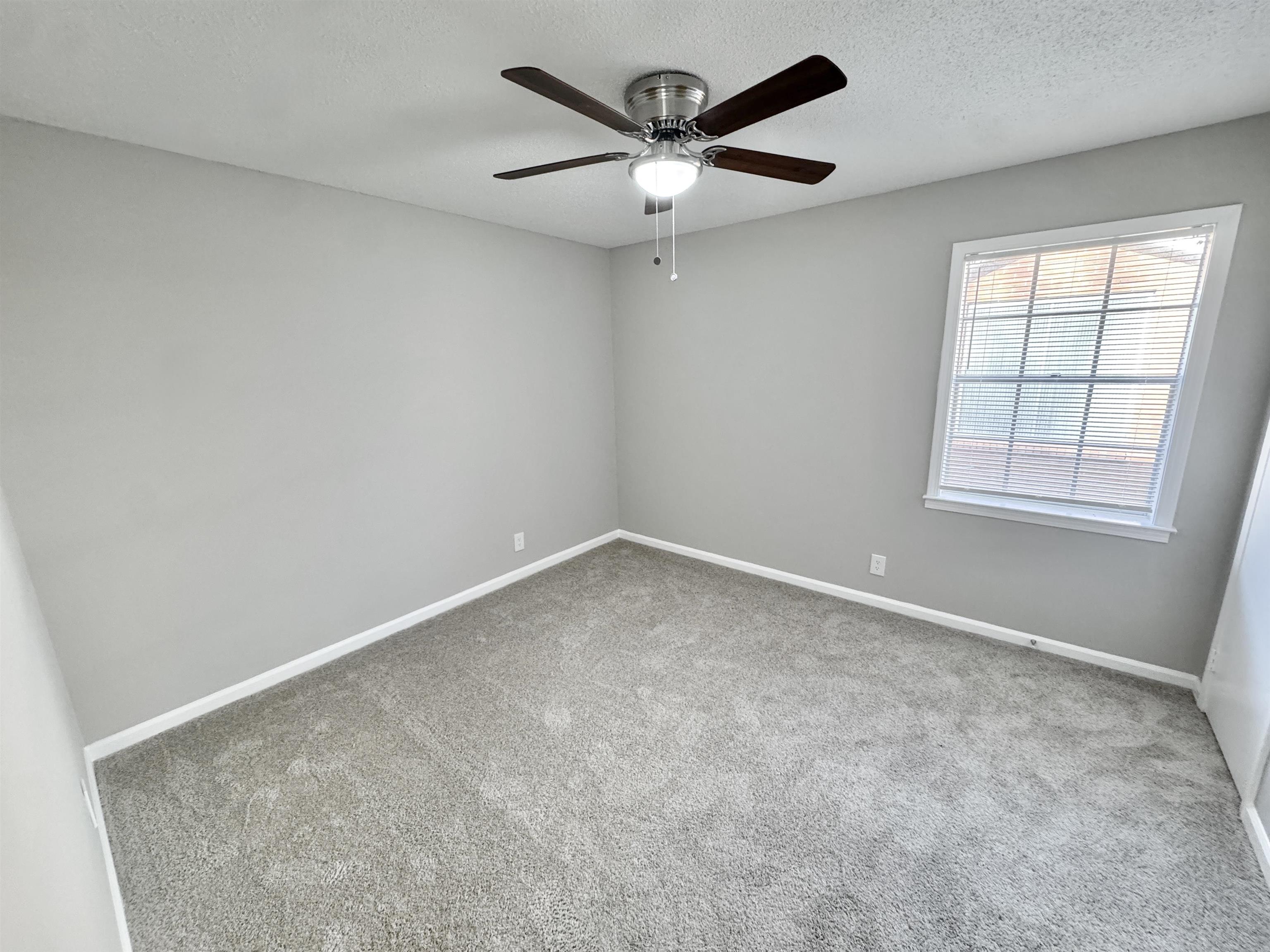 3429 Clarke Road Memphis, TN 38115 - Photo 26 of 33 an empty room with a ceiling fan and window