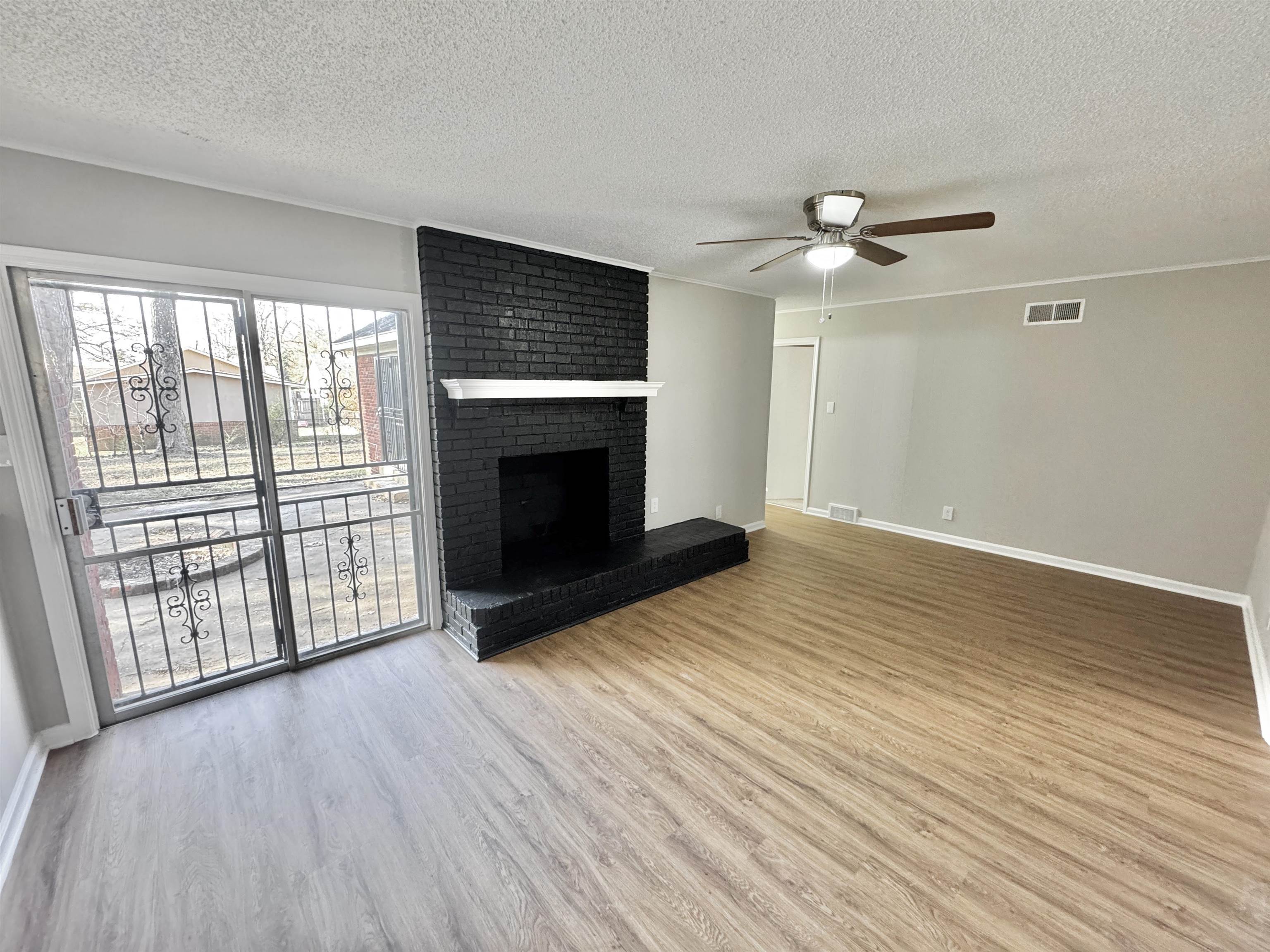 3429 Clarke Road Memphis, TN 38115 - Photo 4 of 33 wooden floor fireplace and natural light in room
