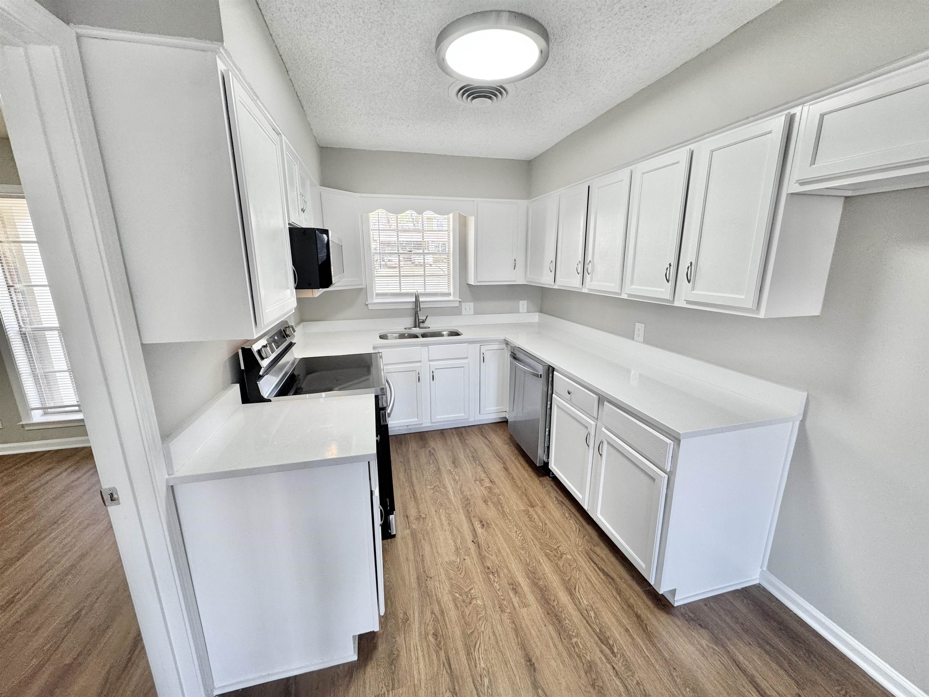 3429 Clarke Road Memphis, TN 38115 - Photo 7 of 33 a kitchen with cabinets a sink and appliances