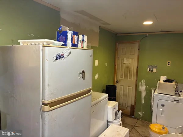 a room with refrigerator and washer