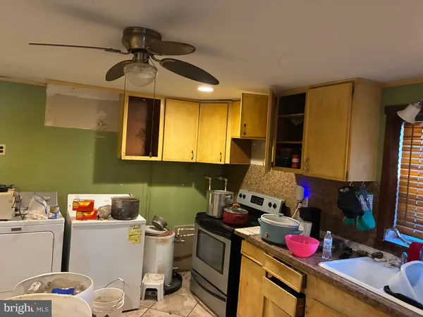 a kitchen with a sink appliances and cabinets