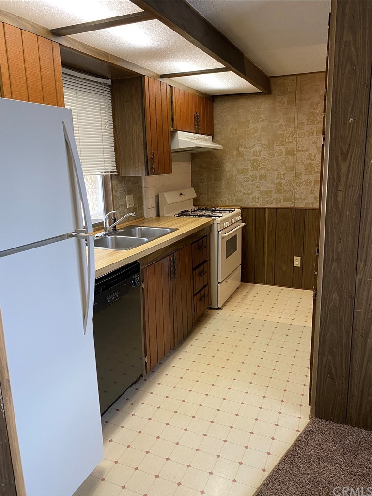 213 Elm Road Blythe, CA 92225 - Photo 12 of 61 a kitchen with a sink a stove and refrigerator