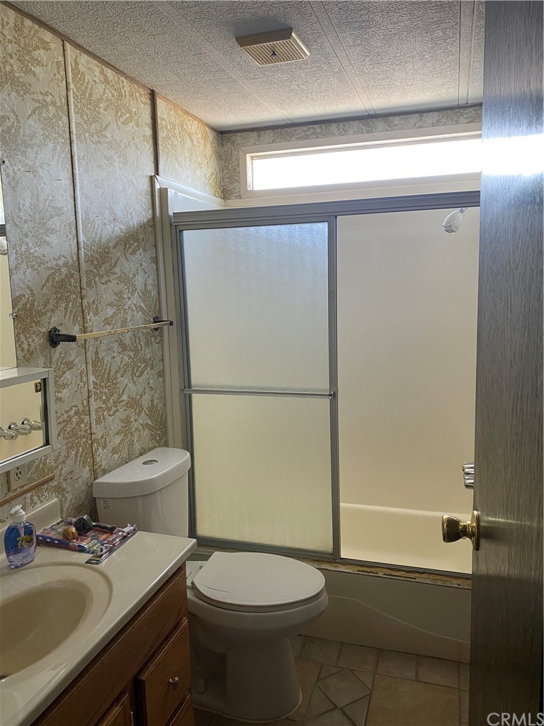 213 Elm Road Blythe, CA 92225 - Photo 16 of 61 a bathroom with a sink a toilet and shower