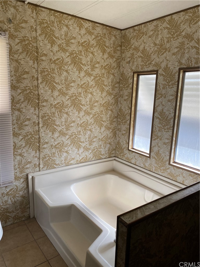 213 Elm Road Blythe, CA 92225 - Photo 20 of 61 a bathroom with a bathtub and a shower