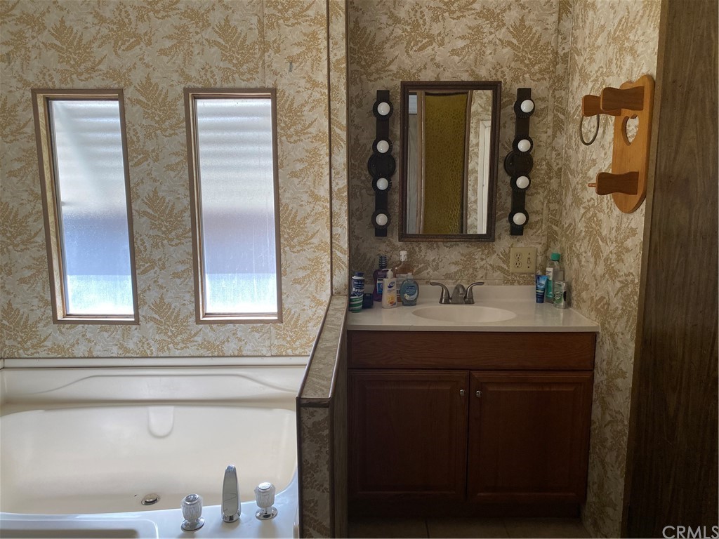 213 Elm Road Blythe, CA 92225 - Photo 22 of 61 a bathroom with a sink and a mirror