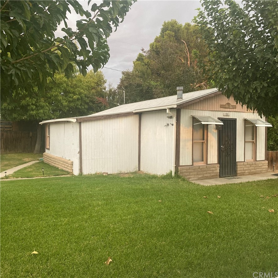 213 Elm Road Blythe, CA 92225 - Photo 24 of 61 a view of a backyard with plants and large tree