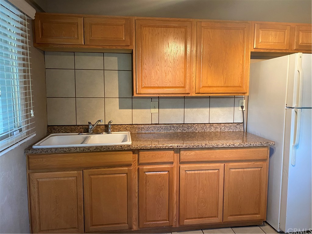 213 Elm Road Blythe, CA 92225 - Photo 60 of 61 a kitchen with granite countertop cabinets and white appliances