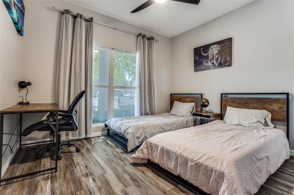 3801 14th Street, Unit 502 Plano, TX 75074 - Photo 7 of 12 a bedroom with two beds and a large window