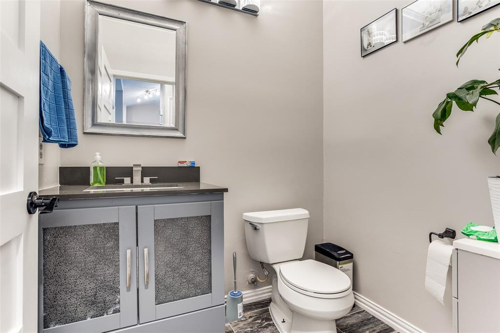 3801 14th Street, Unit 502 Plano, TX 75074 - Photo 8 of 12 a bathroom with a toilet a sink and mirror