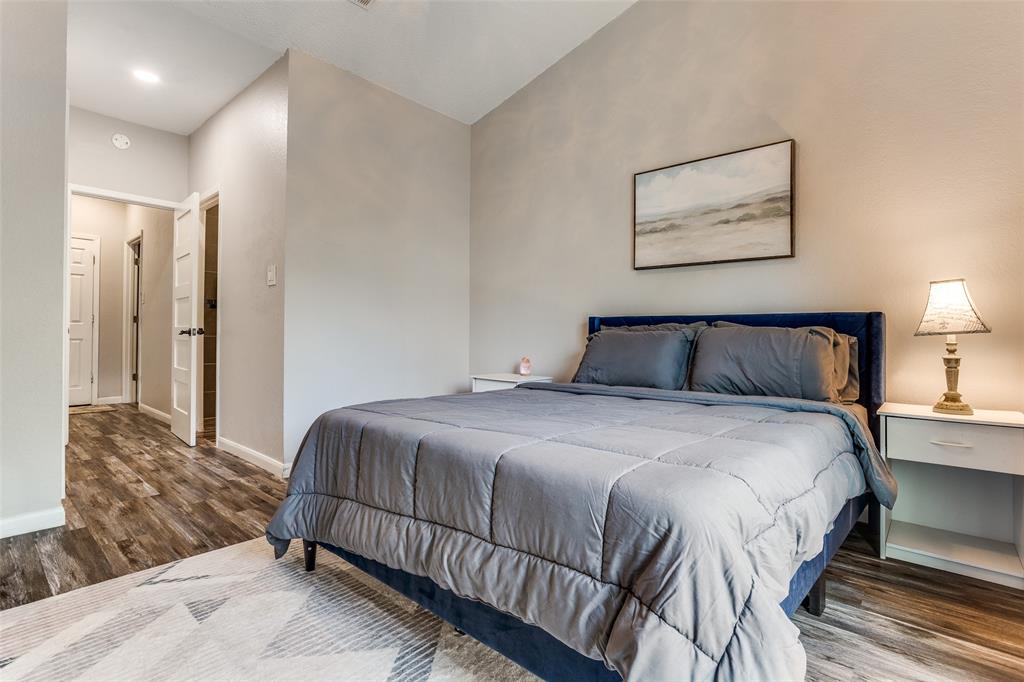 3801 14th Street, Unit 502 Plano, TX 75074 - Photo 10 of 12 a bedroom with a bed and painting on the wall