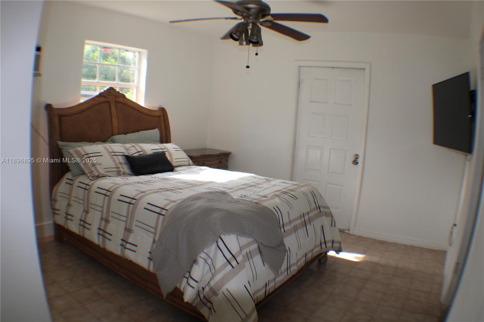 35000 Southwest 212th Avenue Homestead, FL 33034 - Photo 8 of 11 a bedroom with a bed and a television