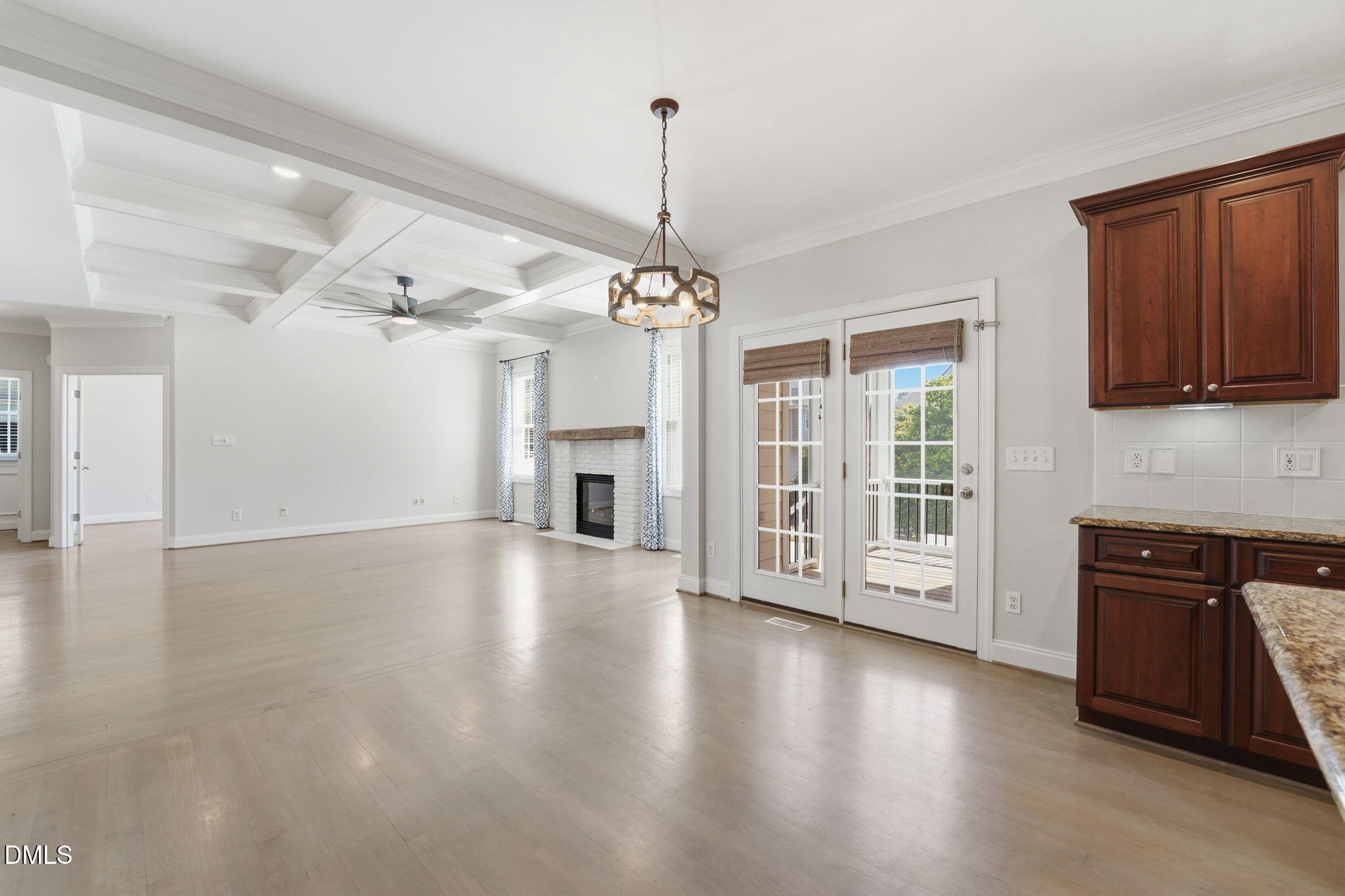 2900 SnapsWell Street Raleigh, NC 27614 - Photo 12 of 40 a view of a living room with wooden floor and a fireplace