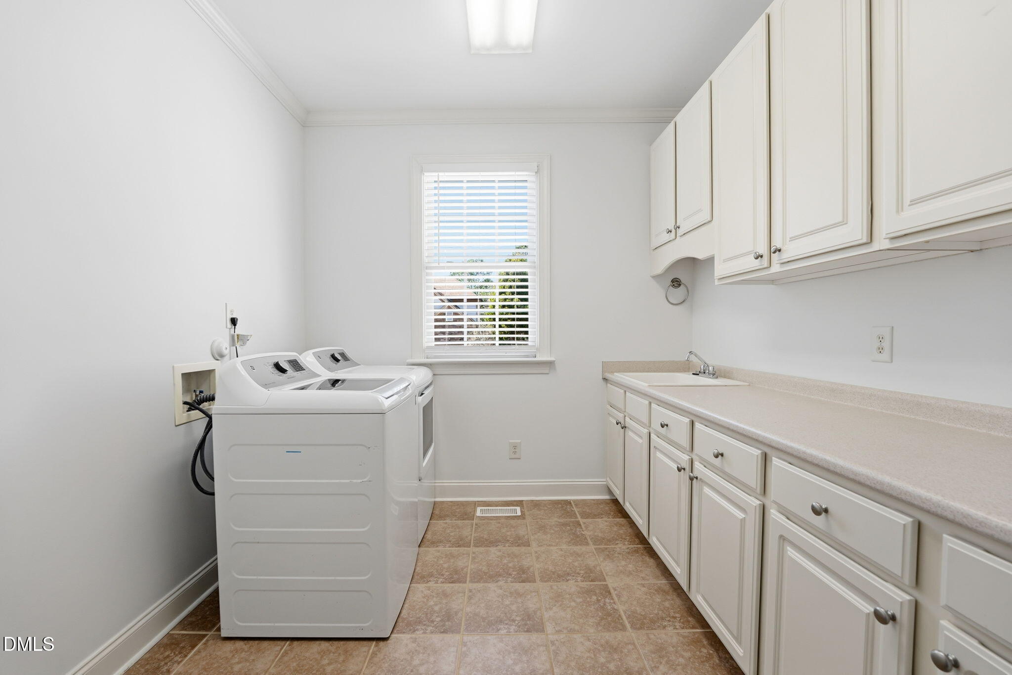 2900 SnapsWell Street Raleigh, NC 27614 - Photo 36 of 40 a utility room with cabinets washer and dryer