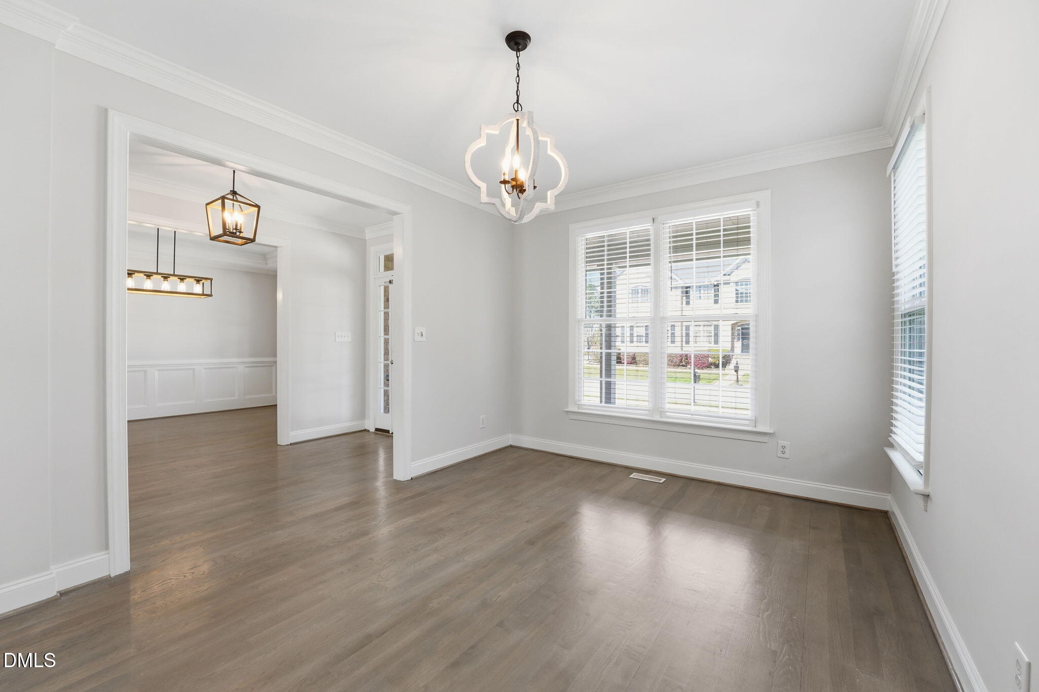 2900 SnapsWell Street Raleigh, NC 27614 - Photo 7 of 40 an empty room with wooden floor windows and a chandelier