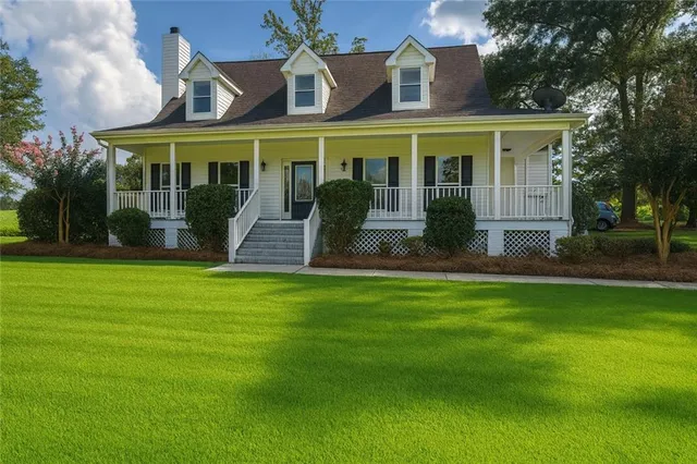 a front view of a house with a garden