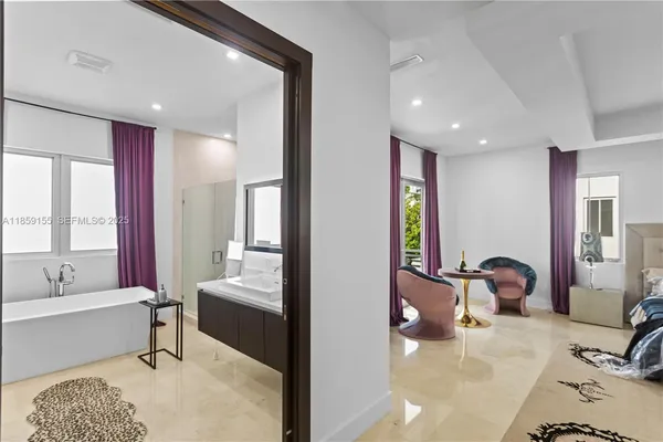a spacious bathroom with a double vanity sink large mirror and a bathtub