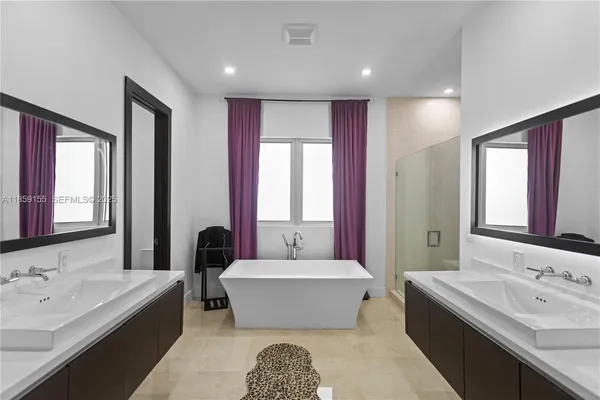 a bathroom with a tub shower and sink
