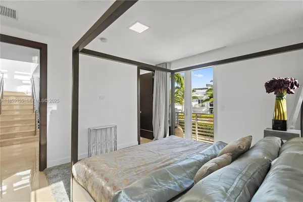 a bedroom with a large bed and a large window