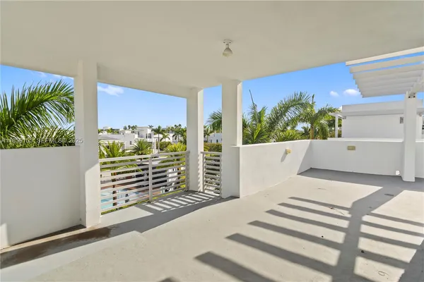 a view of a white house with a yard