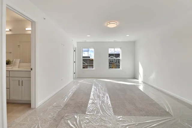 en empty room with windows and entrance