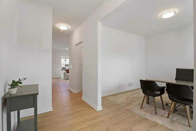 a view of a room with wooden floor furniture and windows