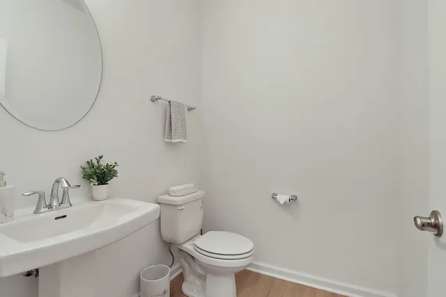 a white toilet sitting next to a bathroom sink