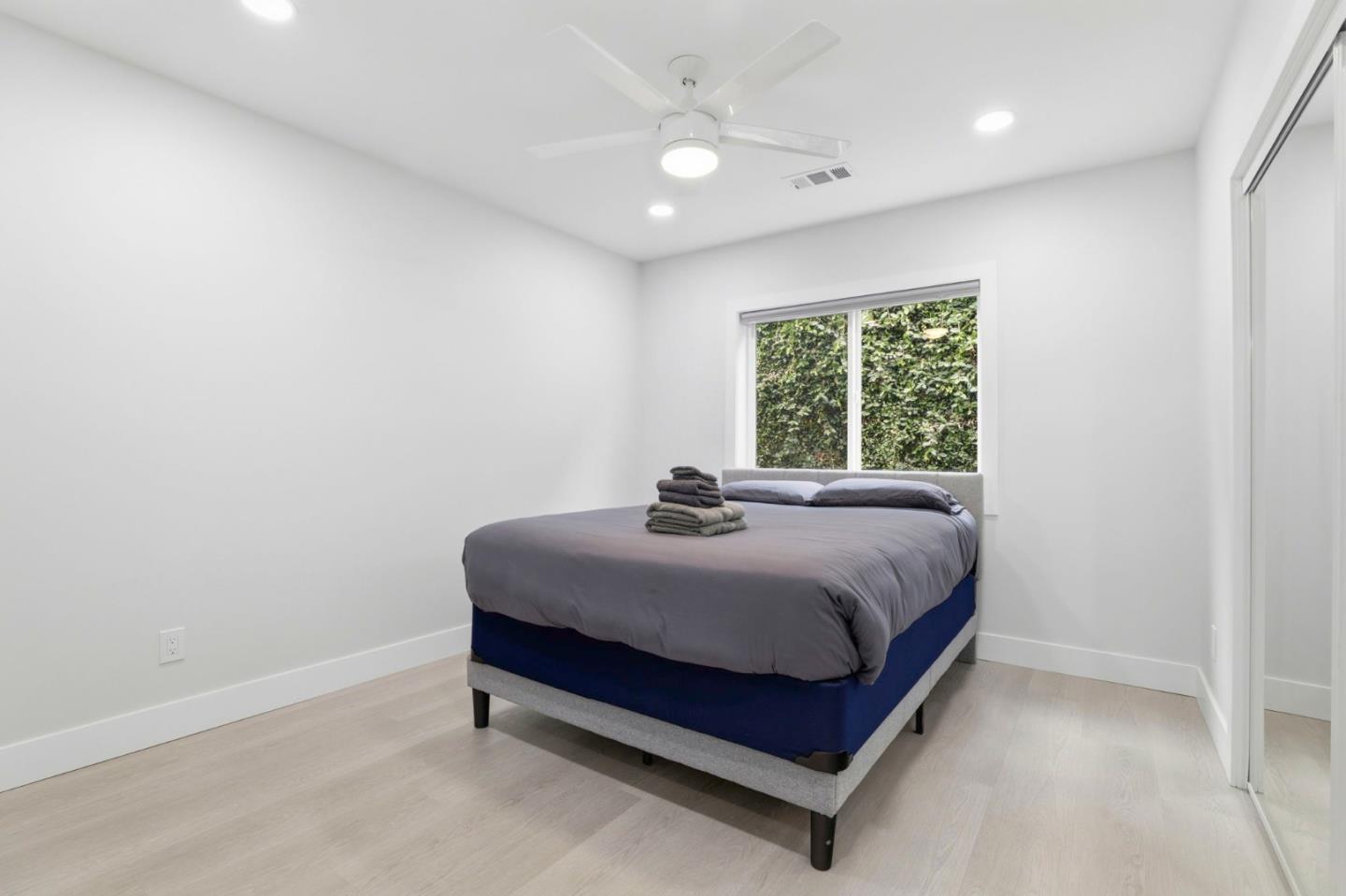 1802 Ponca Court Fremont, CA 94539 - Photo 14 of 28 a bed sitting in a spacious bedroom next to a window