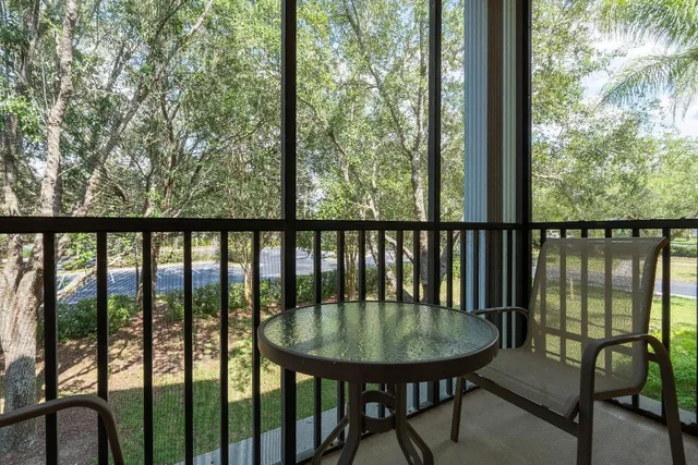 a view of a balcony with a table and chairs