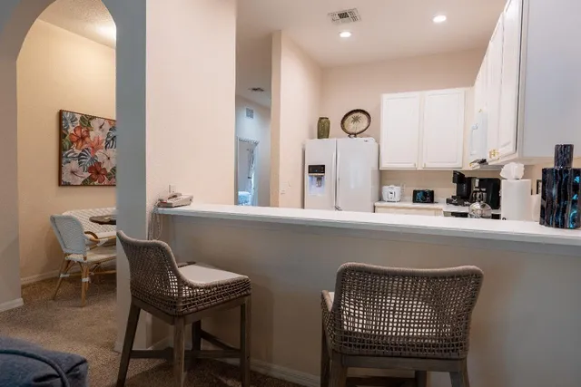 a kitchen with a table chairs and a window