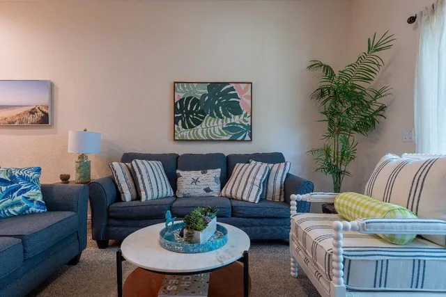 a living room with furniture and a potted plant