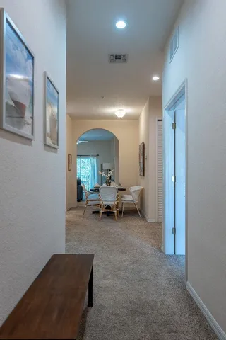 a living room with furniture and a mirror