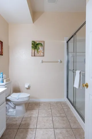 a bathroom with a toilet and a shower